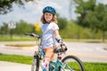 Child riding bicycle. Little kid boy in helmet on bicycle along bikeway. Happy cute little boy riding bicycle. Child in