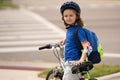 Child riding bicycle. Little kid boy in helmet on bicycle along bikeway. Happy cute little boy riding bicycle in summer