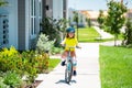 Child riding bicycle. Little kid boy in helmet on bicycle along bikeway. Happy cute little boy riding bicycle in summer