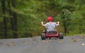 Child Riding a Big Wheel Bike Royalty Free Stock Photo