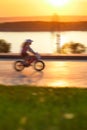 Child riding a bike along river Royalty Free Stock Photo