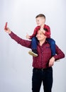 Child riding on dads shoulders. Happiness being father of boy. Having fun. Fathers day. Father example of noble human Royalty Free Stock Photo