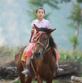 Child riding a horse