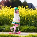Child riding schooter on way to school Royalty Free Stock Photo