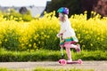 Child riding schooter on way to school Royalty Free Stock Photo