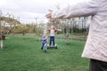 Child riding on self-balancing hover board on the backyard of cottage, outdoor kids activity