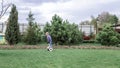 Child riding on self-balancing hover board on the backyard of cottage, outdoor kids activity