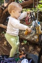 Child of rock climbers playing with quickdraws Royalty Free Stock Photo
