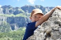 A child rock climbing during an outdoor exercise adventure with mountain scenery