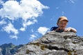 A child rock climbing during an outdoor exercise adventure with mountain scenery