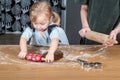 Child Rolling Gingerbread Dough with Holiday Baking Tools in Kitchen Royalty Free Stock Photo