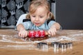 Child Rolling Gingerbread Dough on Kitchen Table with Festive Baking Tools Royalty Free Stock Photo