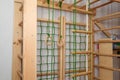 Child room with sport section, playing space, wooden construction for gymnastics, climbing, playing activities. Close up