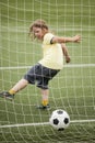 Child run soccer football player. Boy with ball on green grass Royalty Free Stock Photo