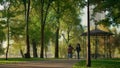 Child running park path enjoying family evening outdoors. Caring people together Royalty Free Stock Photo