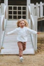 Child running on the playground girl playing games kid 4 years old happy emotions