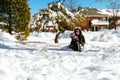 Child running in snowy forest. Toddler kid playing Kids play in snow. Royalty Free Stock Photo