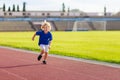 Child running in stadium. Kids run. Healthy sport