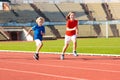 Child running in stadium. Kids run. Healthy sport