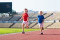 Child running in stadium. Kids run. Healthy sport