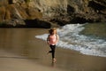 Child running through water close to shore along the sea beach. A boy runs along the sea coast. Rest of children on Royalty Free Stock Photo