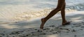 A child runs along the river bank splashing water with his feet. In summer, the child plays on the beach, runs barefoot on the Royalty Free Stock Photo