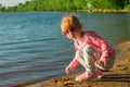 The child runs on the coast in the sand. Royalty Free Stock Photo
