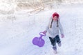 A child runs on a hill in the winter forest. Baby is playing at a ski resort. Concept of active children`s recreation. A cheerful Royalty Free Stock Photo