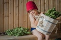 Child in a Russian bath with a birch broom