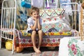 Child Russian or Ukrainian on an old ethnic bed