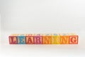 A child`s alphabet toy spelling word block set, spelling out the word learning Royalty Free Stock Photo