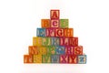 A child`s alphabet toy spelling word block set, spelling out the alphabet in a pyramid shape Royalty Free Stock Photo