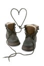 Child's boots form a heart with shoelaces. Royalty Free Stock Photo