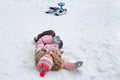 A childÃ¢â¬â¢s falling down from a children sledge in winter Royalty Free Stock Photo