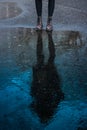 Child`s feet near a blue water puddle Royalty Free Stock Photo