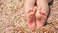Child's feet on the pebbles beach Royalty Free Stock Photo