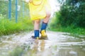 Child`s feet in a rubber boot