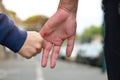 Child`s and female hands closeup. Mother leads her little son, urban outdoor, trust family, childhood and parenting