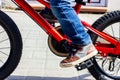 A child& x27;s foot in sneakers turns the bicycle pedal. Riding a child& x27;s bike. Royalty Free Stock Photo