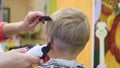 Child`s haircut at the Barber shop