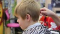 Child`s haircut at the Barber shop