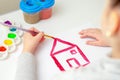 Child`s hand drawing the house Royalty Free Stock Photo