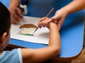 Child's hand with a brush for drawing