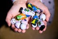 Child`s hand filled with creepy chocolate eyeballs and dolls