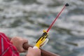 A child`s hand is fishing on a small fishing rod. Ozernaya fishing.