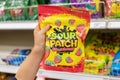 Child`s hand holding a bag of Sour Patch brand soft and chewy candy Royalty Free Stock Photo