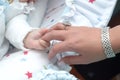 Child`s hand holding his mother, close up Royalty Free Stock Photo