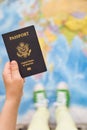 Child's hand holding US passport. Map background. Ready for traveling. Open world Royalty Free Stock Photo