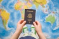 Child`s hand holding US passport. Map background. Ready for traveling. Open world Royalty Free Stock Photo