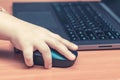 Child`s hand holds a computer mouse, child learns and plays on the computer Royalty Free Stock Photo